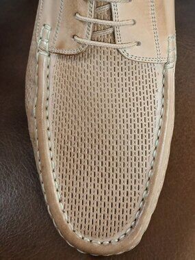 Crisp mens laced camel color loafers.